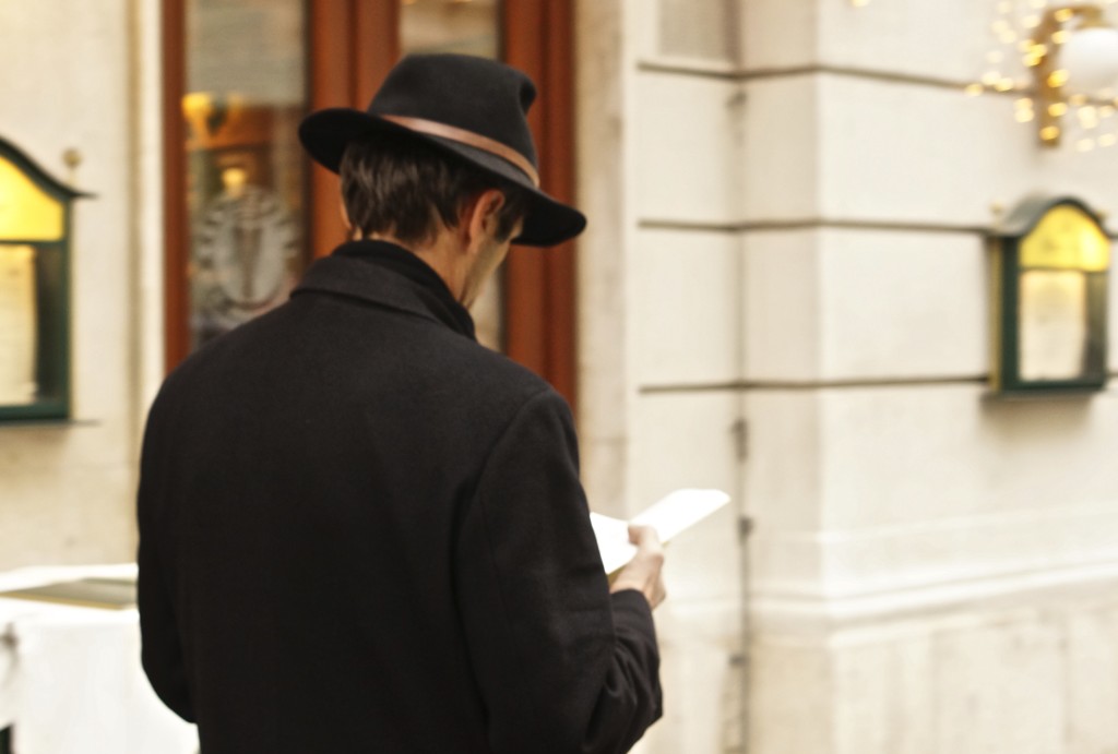 walking and reading viennese men wearing apline hat distracted walking