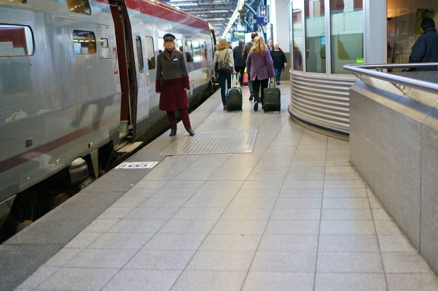 thalys train platform brussels midi station attendant red